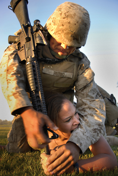 The Norman Hatch Combat Photography Award 2nd Place - LCpl. Gregory Aalto: A Marine acting as an aggressor bites Pfc. Anthony Rubio, artilleryman with 3rd