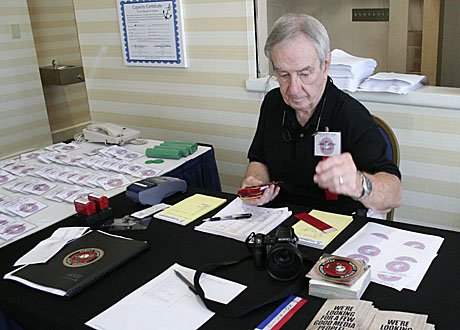 Jack Paxton, executive director mans the registration desk on day one of the USMCCCA conference in Hampton, Virg.