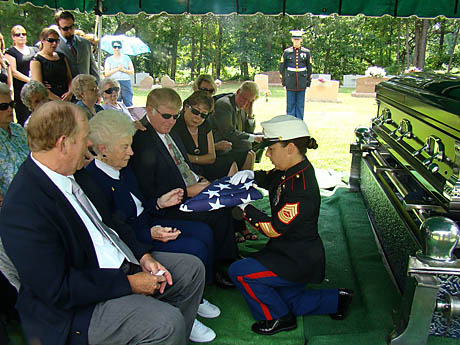 Gloria Funk receives John’s Colors from the unidentified NCOiC of the Funeral Detail at ceremonies on June 25 at Forest Lawn Cemetery, Norfolk, VA (Photo by Jack Paxton)