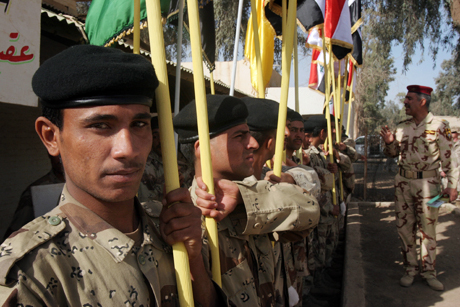 Honorable Mention Stand Alone Photograph by LCpl. Robert Medina: HABBANIYAH, Iraq – Iraqi Soldiers from 4th Brigade, 7th Division, lower their flags as another Soldier removes them for storage at the Basic Combat Training course here Mar. 9. More than 900 Soldiers graduated the course. The course is six weeks long and provides instruction in military drill, tactical maneuvers and marksmanship. The marksmanship training is supervised and instructed by U.S. Marines at the Advanced Infantry Training Center here. The AITC graduated approximately 14,000 Iraqi Soldiers and Police officers from its course in 2007, which is just 2,000 less than the number of recruits who graduated from Marine Corps Recruit Depot, Parris Island, S.C. The BCT recruits are instructed primarily by Iraqi Soldiers.