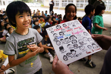 News Photography 1st Place - Cpl. Richard S. Blumenstein: URUMA CITY, Okinawa - Students from Iha Elementary School present Marines with gifts as a sign of appreciation at the school March 12. Twelve Marines from 9th Engineer Support Battalion, 3rd Marine Logistics Group, volunteered their time to teach Okinawan children English and host an Easter egg hunt.