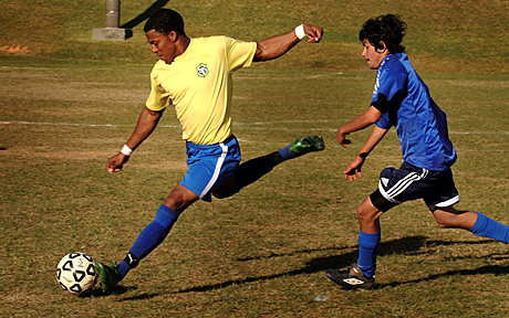 The Megan McClung Sports Photography Award 1st Place - LCpl. Kentavist P. Brackin: Greg Arnell (left) prepares a shot on goal while Patrick Reynolds, Mil United forward, attempts to stop him during the finals of the Far East Finale Open 6-on-6 Soccer Tournament on Camp Schwab Sunday. Arnell made the shot and was awarded most valuable player by teammates for his performance during the tournament. 