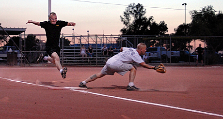 The Megan McClung Sports Photography Award Honorable Mention -  LCpl. Gregory Aalto: Nickolas Rubio, Marine Aviation Weapons and Tactics Squadron 1 centerfielder, stretches his foot toward first base in MAWTS-1 victory against Marine Wing Support Squadron 371 Fuels here Monday. MAWTS-1 beat Fuels 15-14 to move on to the winner’s bracket semifinals of the second season intramural softball championships.